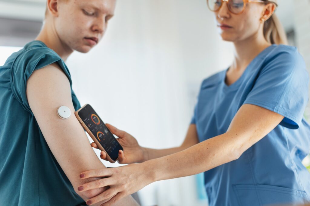 A nurse checks the vitals recorded by a remote